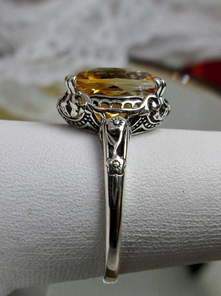 Natural Citrine Ring, Oval yellow citrine gemstone, sterling silver floral filigree, Edward Design #D70z, side view on a ring holder