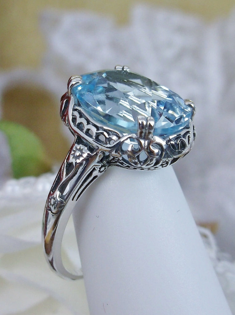 Natural Sky Blue Topaz Ring, 4.5 carat oval faceted stone, sterling Silver floral filigree, Edward design #D70z, offset side view on ring form
