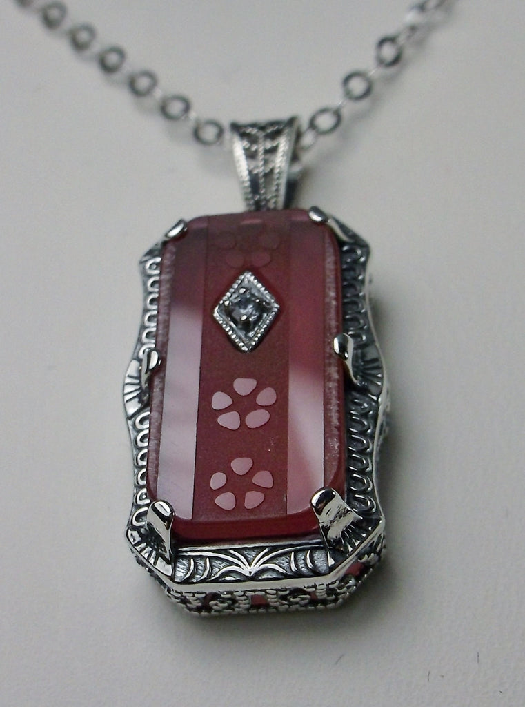 Pink Camphor Glass pendant, with sterling silver filigree edging with three prongs, etched floral detail on the face of the glass and a CZ accent gem, Silver Embrace Jewelry
