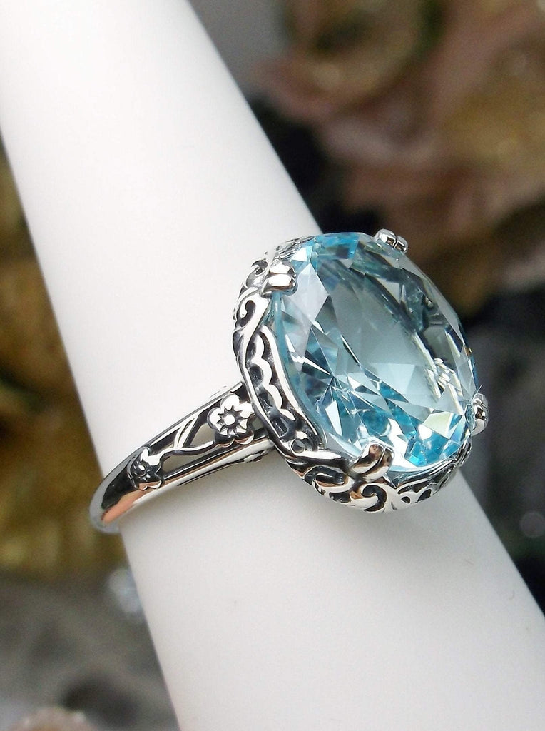 Side view of Sky Blue Aquamarine Ring, Sterling Silver floral filigree, Edward Design#D70z on a ring holder