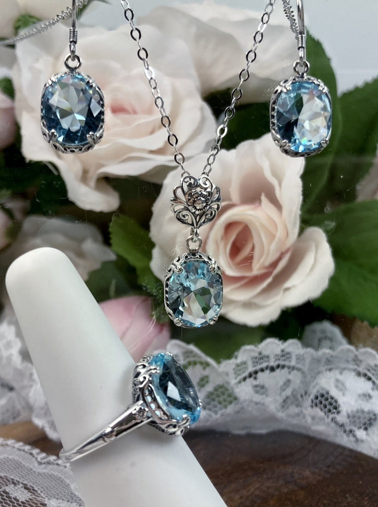 aquamarine jewelry set with sky blue oval stones and antique floral filigree, includes earrings, pendant with chain and floral bail and antique reproduction ring, Edward Design#70z
