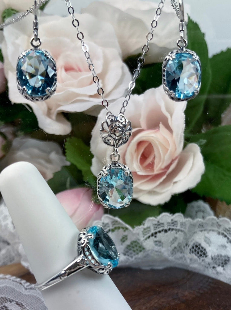 aquamarine jewelry set with sky blue oval stones and antique floral filigree, includes earrings, pendant with chain and floral bail and antique reproduction ring, Edward Design#70z