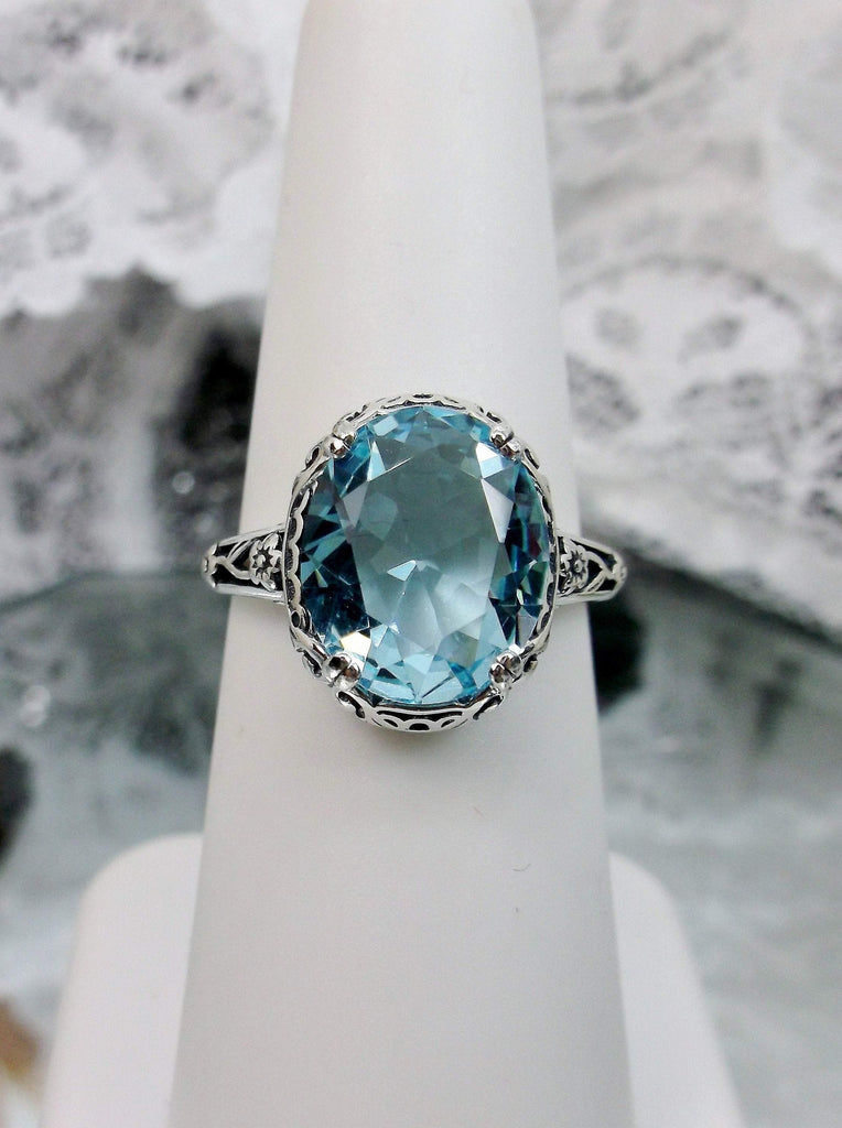 Front View of Sky Blue Aquamarine Ring, Sterling Silver floral filigree, Edward Design#D70z on a ring holder