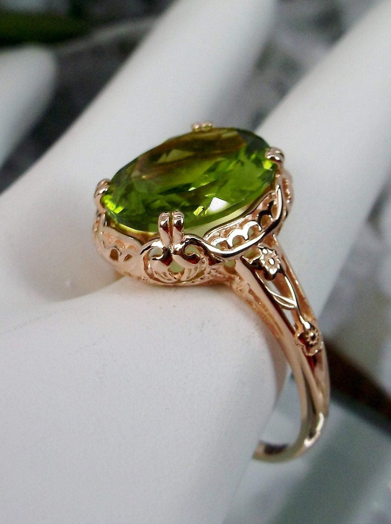 Natural Peridot Ring, 4 carat natural Green Peridot oval gemstone, Rose Gold over Sterling Silver floral Filigree, Edward design #D70z, offset view on hand form